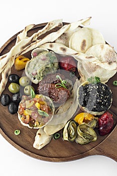 vegan tapas snacks sharing platter board on white background