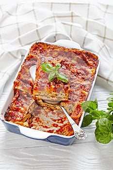 Vegan tofu lasagna on wooden background, close-up