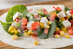 Vegan tofu wraps with pepper, corn, tomatoes and spinach