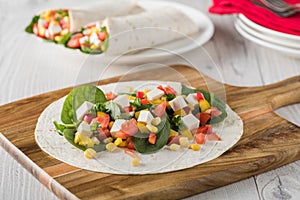 Vegan tofu wraps with pepper, corn, tomatoes and spinach