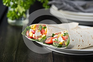 Vegan tofu wraps with pepper, corn, tomatoes and spinach