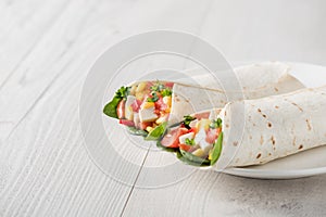 Vegan tofu wraps with pepper, corn, tomatoes and spinach