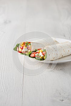 Vegan tofu wraps with pepper, corn, tomatoes and spinach