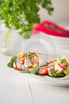 Vegan tofu wraps with pepper, corn, tomatoes and spinach