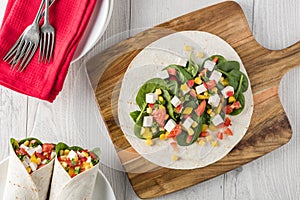 Vegan tofu wraps with pepper, corn, tomatoes and spinach