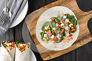 Vegan tofu wraps with pepper, corn, tomatoes and spinach