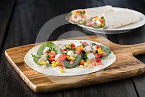 Vegan tofu wraps with pepper, corn, tomatoes and spinach