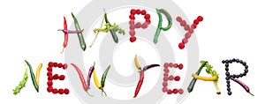 vegan vegetable colourful letters HAPPY NEW YEAR made from berry, raspberry, blueberries, carrots, chilis and celery