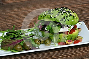 Vegan or vegetarian avocado burger on a plate as healthy food alternative