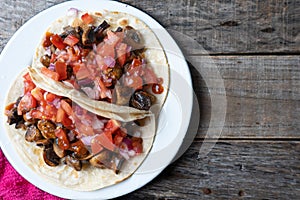 Vegan and vegetarian mexican mushrooms tacos with sauce and lime