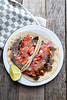 Vegan and vegetarian mexican mushrooms tacos with sauce and lime