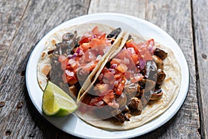 Vegan and vegetarian mexican mushrooms tacos with sauce and lime