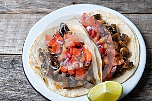 Vegan and vegetarian mexican mushrooms tacos with sauce and lime