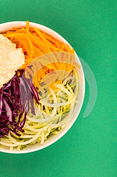 Vegan or Vegetarian Salad Bowl With Red Cabbage Courgettes Carrots And Hummus