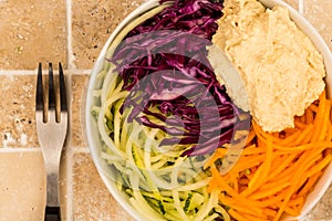 Vegan or Vegetarian Salad Bowl With Red Cabbage Courgettes Carrots And Hummus