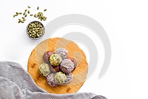 Vegen energy balls with pumpkin seeds and coconut, overhead view