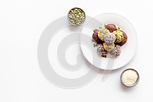 Vegen energy balls with pumpkin seeds and coconut, overhead view