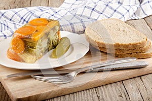 Vegetable aspic and bread on a wooden board