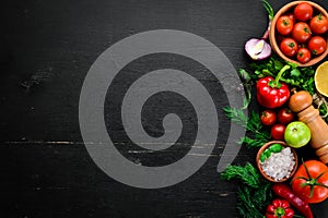 Vegetable background. Fresh tomatoes, paprika, onions and parsley on the table.