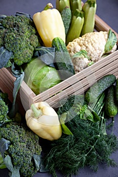 Vegetable basket. Fresh vegetables on the table black background. Set of food delivery box. Broccoli, cabbage, eggplant