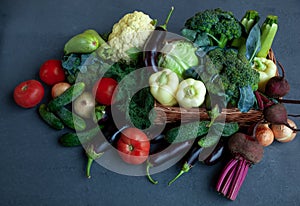 Vegetable basket. Fresh vegetables on the table black background. Set of food delivery box. Broccoli, cabbage, eggplant