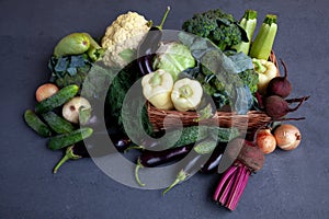 Vegetable basket. Fresh vegetables on the table black background. Set of food delivery box. Broccoli, cabbage, eggplant