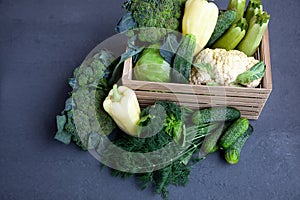 Vegetable basket. Fresh vegetables on the table black background. Set of food delivery box. Broccoli, cabbage, eggplant