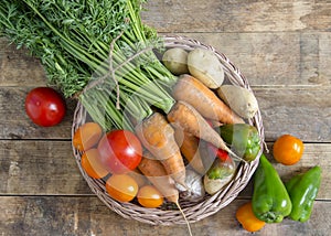 Vegetable basket on a wooden table, in rustic style.