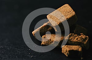 Vegetable bouillon cubes on stone kitchen board, stock or broth ingredient for soup