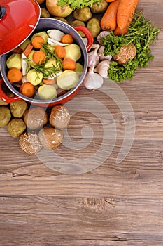 Vegetable casserole dish or stew pot with organic vegetables and copy space, vertical