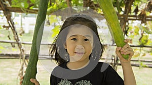 Vegetable child girl play hold squash concept