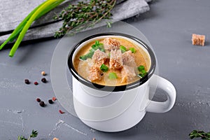 Vegetable cream soup with croutons in mug