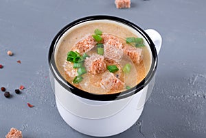 Vegetable cream soup with croutons in the mug