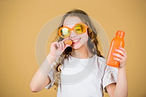 Vegetable diet. happy girl drink fresh carrot juice. summer vacation. little girl in fashion glasses. Vitamin nutrition