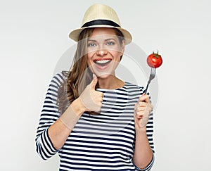 Vegetable dieting concept portrait with young woman holding tomato