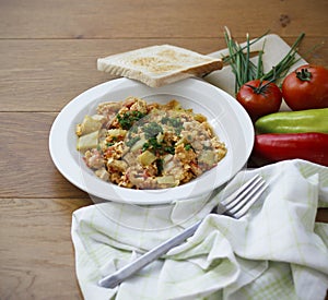 Vegetable dish called lecho containing peppers, tomatoes, onion, eggs and tofu