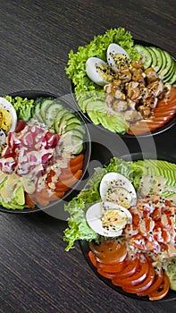 Vegetable and fish salad with tomatoes, cucumbers and avocado. Boiled egg. Bowl.