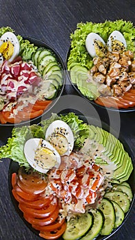 Vegetable and fish salad with tomatoes, cucumbers and avocado. Boiled egg. Bowl.