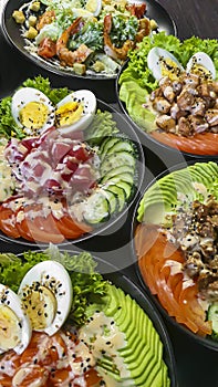 Vegetable and fish salad with tomatoes, cucumbers and avocado. Boiled egg. Bowl.