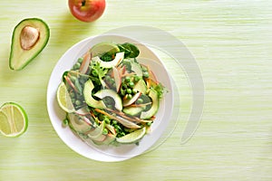 Vegetable fruit salad with avocado, green pea, greens, apple