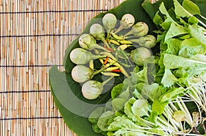 Vegetable on leaf and bamboo blind floor