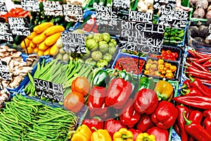 market with fresh appetizing sweet red pepper and other crops with price tags on the counter