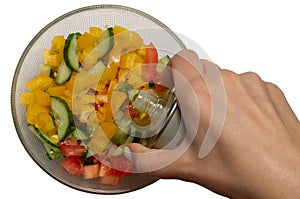 Vegetable oil pour to glass bowl with vegetarian salad. Sliced tomato, cucumber, paprika, green onion, dill and parsley