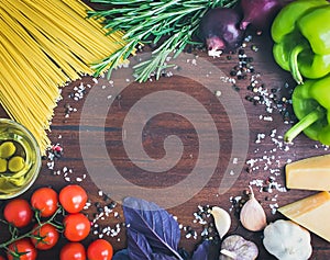 Vegetable pasta ingredients: spaghetti, peppers, tomatoes, basil