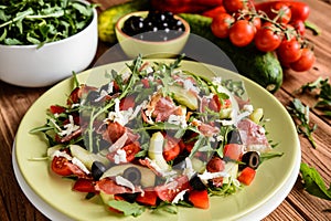 Vegetable salad with Black Forest ham, arugula, cucumber, black olives, red pepper, tomato and Mozzarella