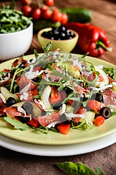 Vegetable salad with Black Forest ham, arugula, cucumber, black olives, red pepper, tomato and Mozzarella