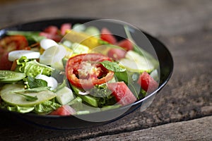 Vegetable salad on a black plate Weight loss concept Healthy food