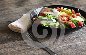 Vegetable salad on a black plate Weight loss concept Healthy food