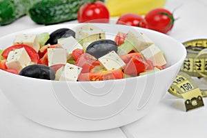 Vegetable salad in a bowl on a wood table with centimeter
