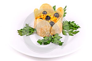 Vegetable salad covered with corn and potato chips